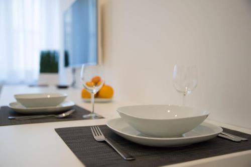 
a white table topped with plates and bowls of food at Barcode Apartments Zrinjevac in Zagreb
