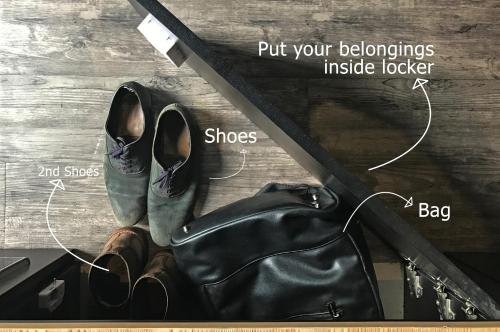 a picture of shoes and a bag on a shelf at My Studio Hotels Kualanamu Airport Medan in Medan