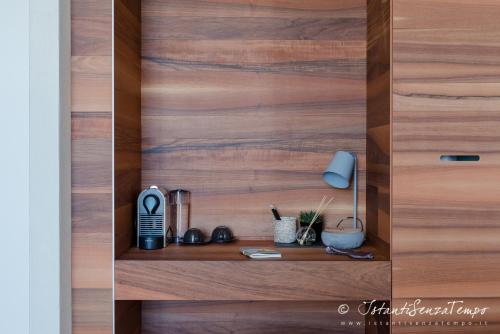 a wooden closet with a wooden door with a shelf at Cumeja Beach Club & Hotel in Baia Domizia