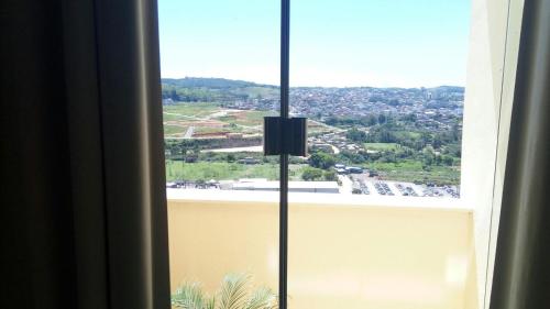 a view of a city from a window at Hotel Potencial in Conselheiro Lafaiete