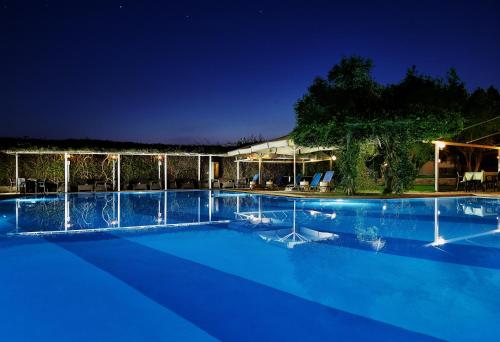 a large swimming pool at night at Miramare in Eretria