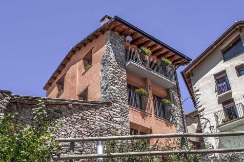 a building with two balconies on the side of it at Cal Pastisser de Taús in Taús