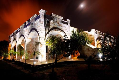 a large building with an archway at night at Relais Villa Lucia in Carovigno