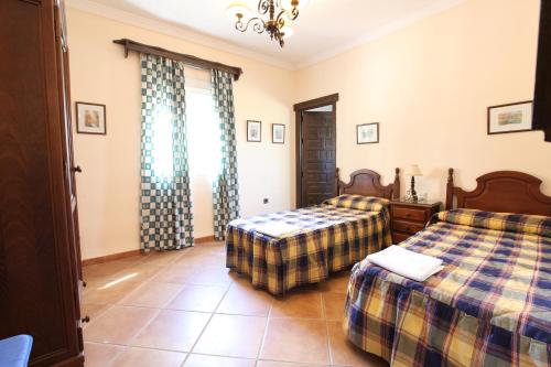 a bedroom with two beds and a window at Chalet San Jose in Seville