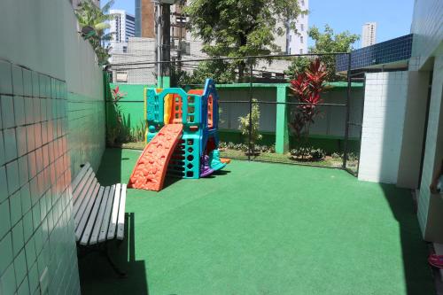 a playground with a slide in a backyard at Apartamento Alice Tenório in Recife
