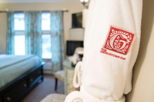 a hotel room with a towel hanging on a wall at The Georgetown Inn in Canmore