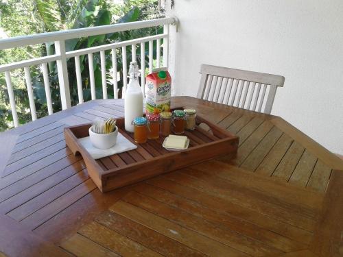 a wooden table with a tray of drinks on a deck at Gites Kas'a Flo in Trois-Rivières
