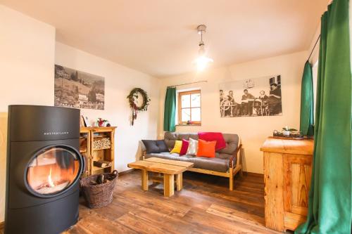 a living room with a fireplace and a couch at Das Prinzis in Lofer