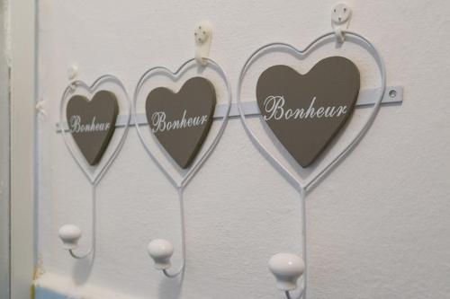 a group of three hearts hanging on a wall at Casa Primavera in Bergamo