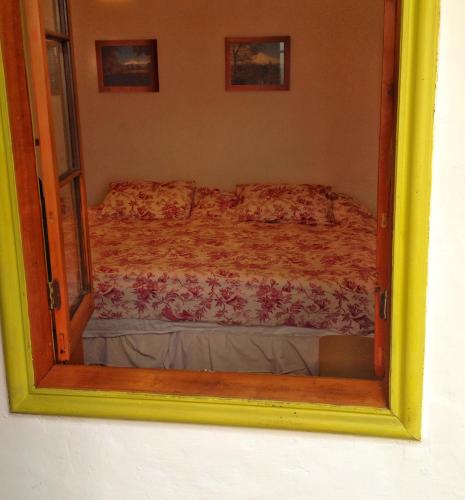a mirror reflecting a bed in a bedroom at Tralkan B&B in Santiago