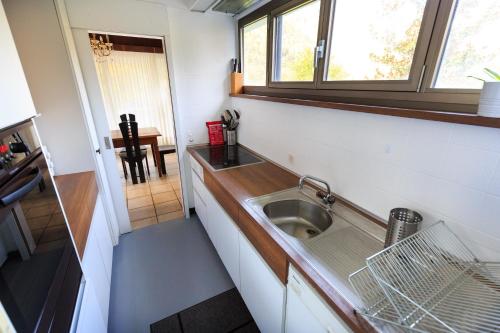 a small kitchen with a sink and a window at Villa delle Palme in Coglio