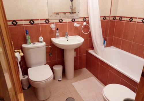 a bathroom with a toilet and a sink and a tub at Casa Montemar Algorfa Spain in Castillo de Montemar