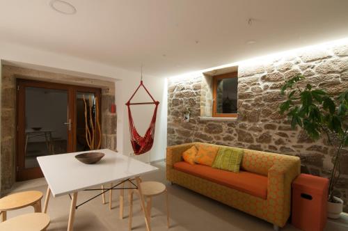 a living room with a couch and a table at Outeiro de Setecamiños in Cuntis