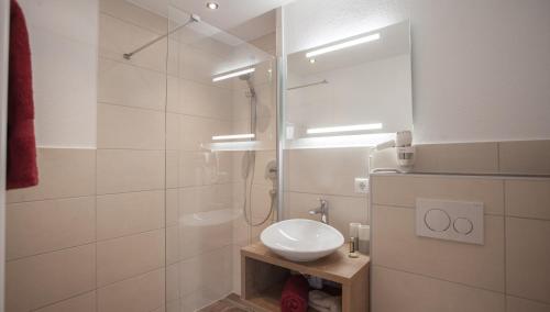 a bathroom with a sink and a shower at Apart Hotel Arno in Sölden