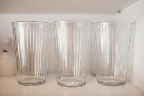 three empty glasses sitting on a table at Apartament 3 - Bliżej Zdroju in Polanica-Zdrój