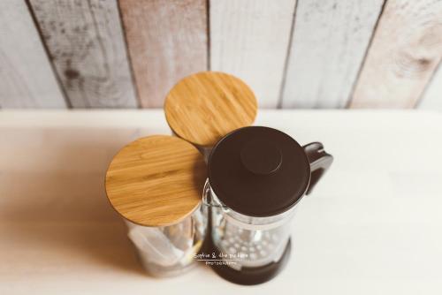 two wooden tops on top of a bottle of syrup at Apartament 3 - Bliżej Zdroju in Polanica-Zdrój