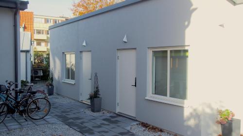 a group of bikes parked next to a white building at PAX Apartments in Lund