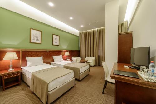 A bed or beds in a room at Alarus Luxe Hotel