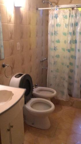 a bathroom with a toilet and a sink and a shower at Hotel del Faro in Mar del Plata