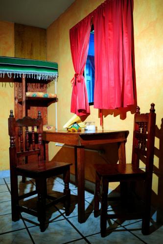 a room with a desk and two chairs and a window at Hotel Colorado in Playa del Carmen