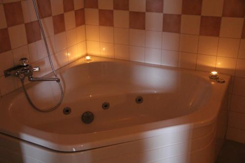 a bath tub with lights in a bathroom at Hotell Karolinen Åre in Åre