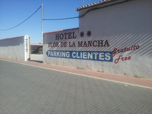 a sign on the side of a building at Hotel Flor de la Mancha in La Roda