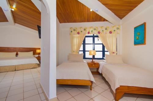 מיטה או מיטות בחדר ב-Hotel Fiesta