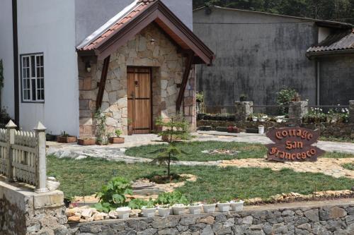 a small house with a sign in front of it at Cottage San Francesco in Nuwara Eliya