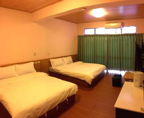 Voodi või voodid majutusasutuse Shanputao Yi Zhan Homestay toas