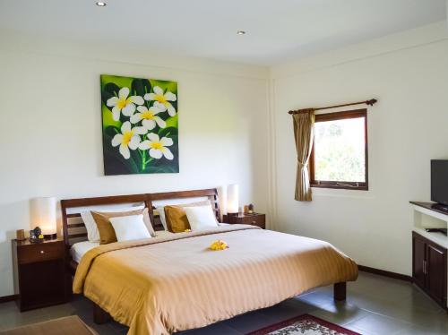 a bedroom with a large bed and a window at Seminyak Villa Lumina in Seminyak