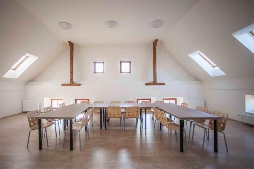 a large room with tables and chairs and skylights at Agropenzion U Bartousku in Malíkovice