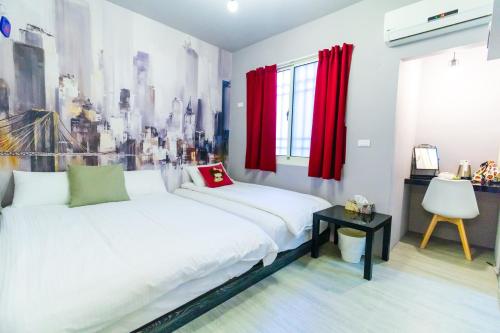 a bedroom with a white bed and red curtains at Long house in Taichung