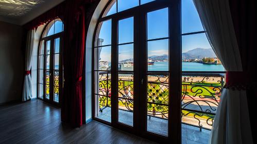 a view through a window of a balcony overlooking a city at The Admiral Hotel in Batumi