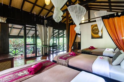 A bed or beds in a room at Hillside - Nature Lifestyle Lodge