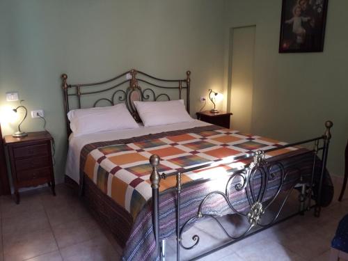 a bedroom with a bed with a checkered blanket at La Casa dei Nonni B&B in Scanno