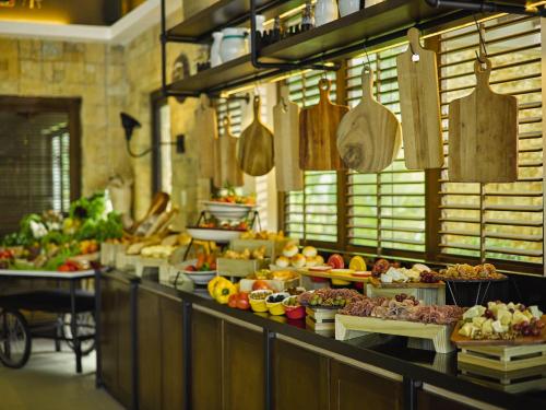 a buffet line with many different types of food at Movenpick Resort & Spa Boracay in Boracay