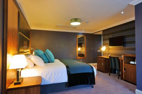 a hotel room with a bed and a television at Rox Hotel Aberdeen by Compass Hospitality in Aberdeen
