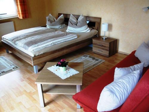バート・フランケンハウゼンにあるFerienwohnung am Kurparkのベッドルーム1室(ベッド1台、テーブル、ソファ付)