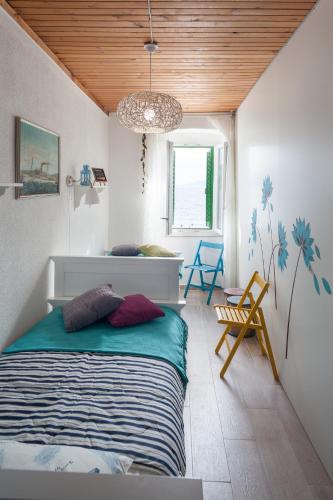 a bedroom with a bed and a chandelier at Stonehouse Katarina in Igrane