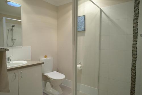 a bathroom with a shower and a toilet and a sink at Cape Villas 23 in Dunsborough