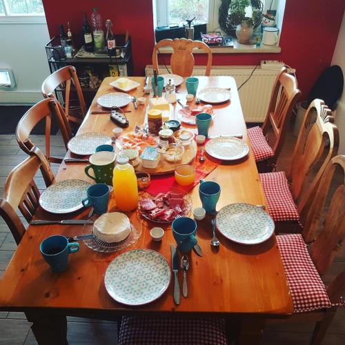 a wooden table with plates and utensils on it at Seminar und Landhaus Schönbeck in Schönbeck