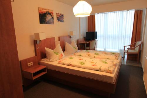 a bedroom with a large bed in a room at Pension Dreiländereck in Birx