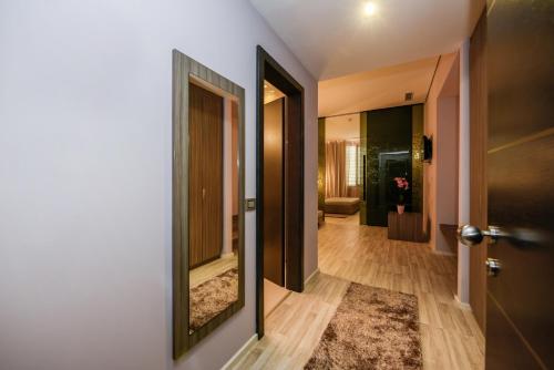 a hallway with two mirrors on a wall at Sky Hotel Tirana in Tirana