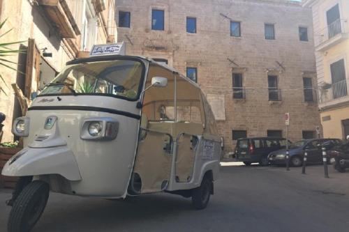 a small car driving down a city street at Ciack si...dorme! in Taranto