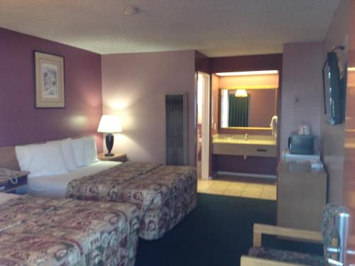 a hotel room with two beds and a bathroom at Blue Seal Inn in Pismo Beach