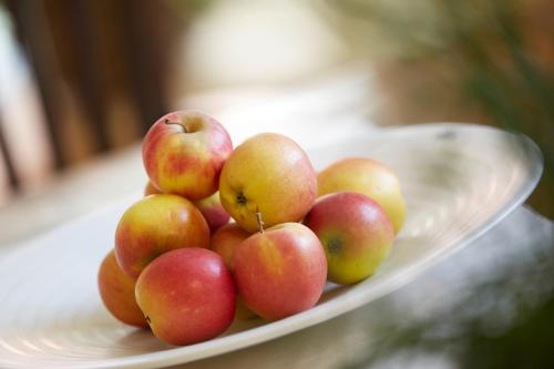 a pile of apples on a plate on a table at Kochs Stadthotel in Olpe