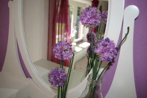 Risum-LindholmにあるFerienhaus Klookris 15の鏡前紫花瓶