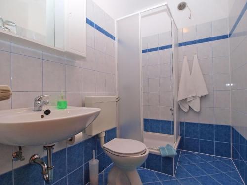 a bathroom with a toilet and a sink at Rooms Ivica 1452 in Fažana