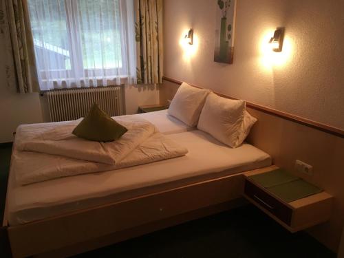 a bed with two pillows on it in a room at Haus Alpina in Kaunertal