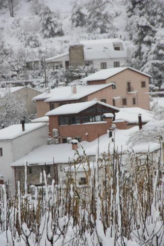 a group of buildings with snow on them at El Molí de Pontons suites con jacuzzi spa in Pontons
